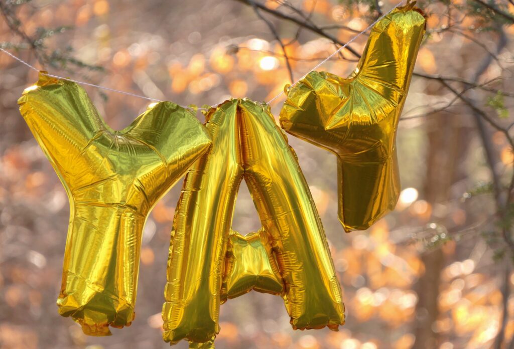 a gold balloon in the shape of a word