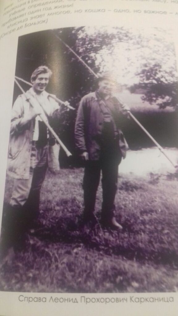 a couple of men holding poles