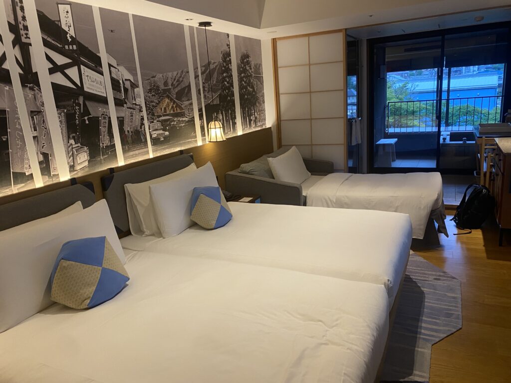 a room with two beds and a picture of a city