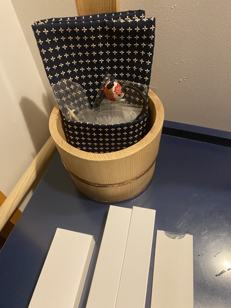 a bucket with a bag and a box on a table