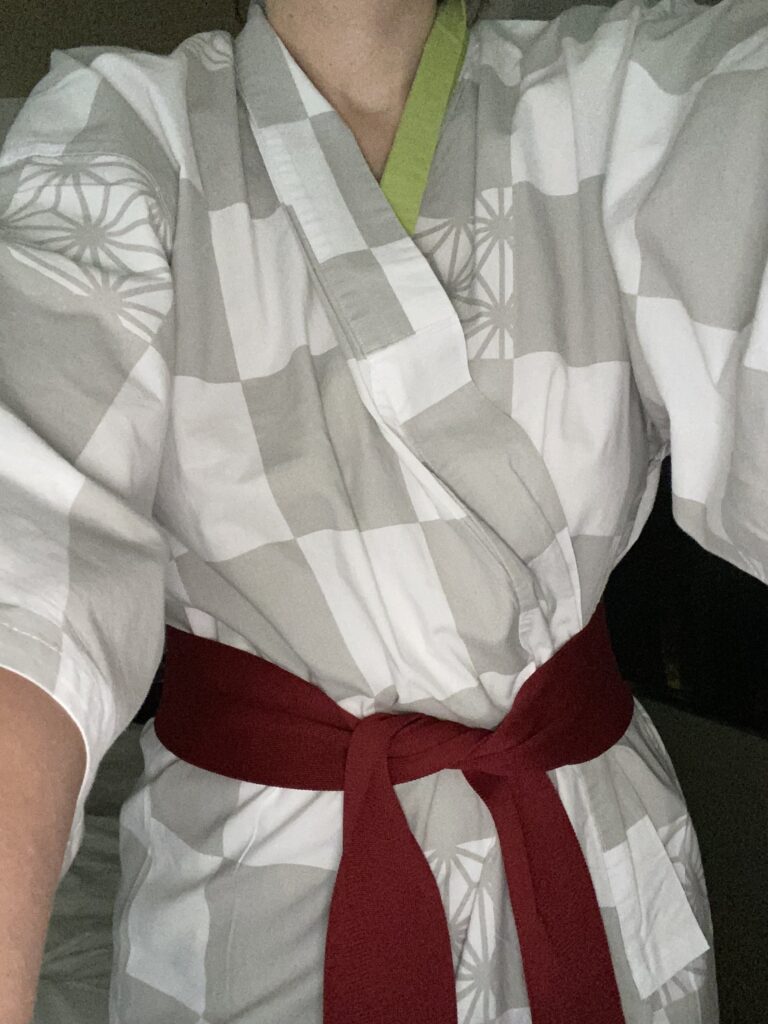 a person wearing a white and grey robe