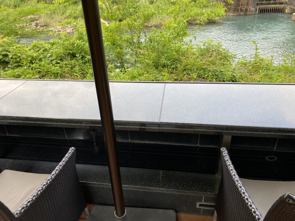 a table and chairs overlooking a river