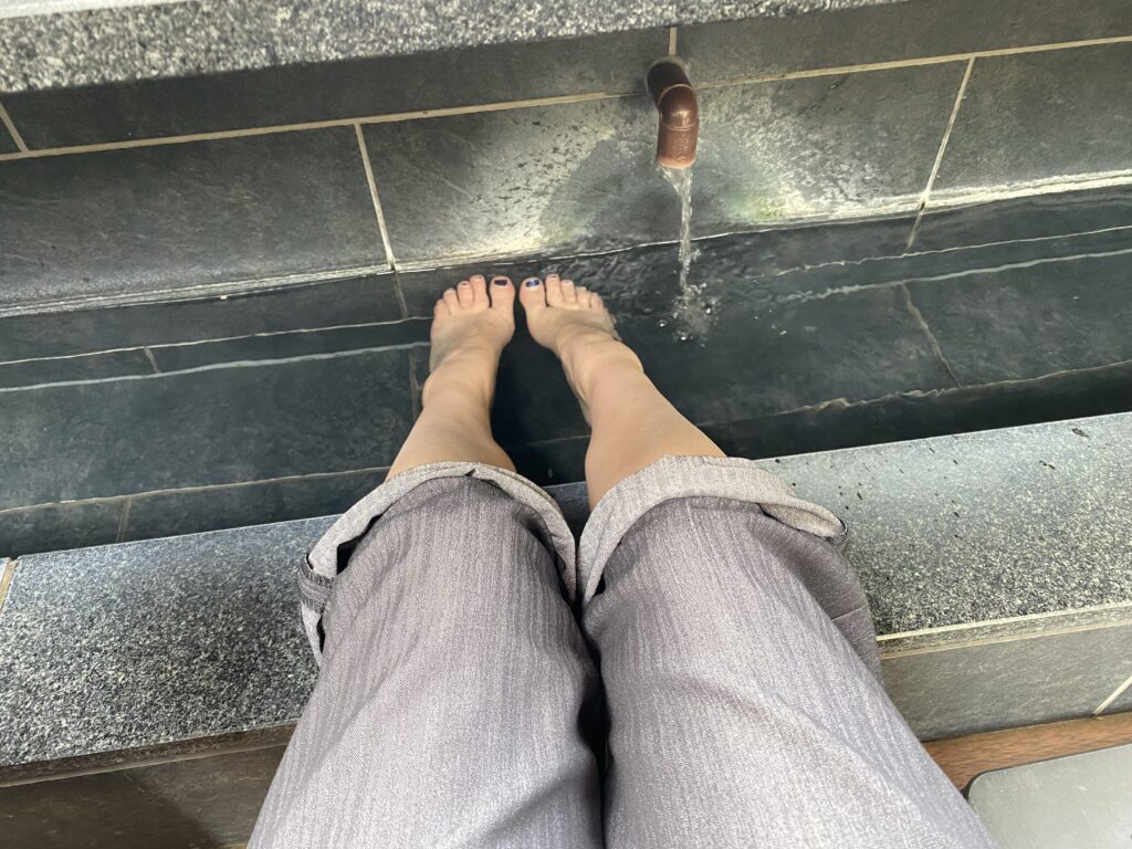 a person's feet in a fountain