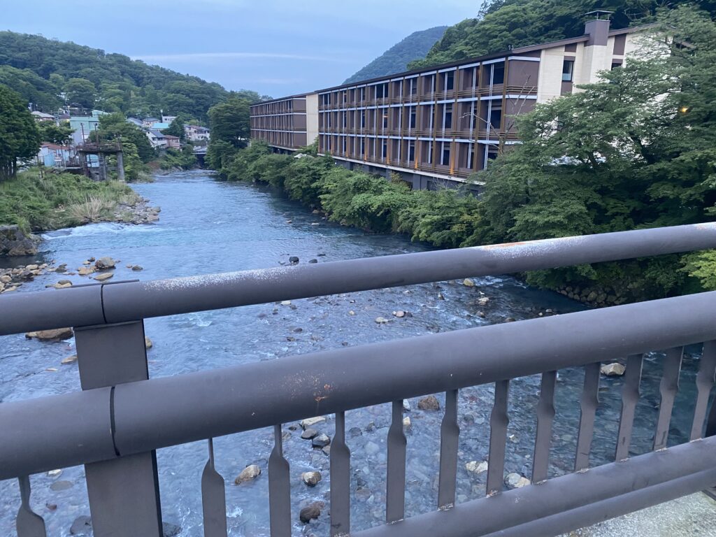 a bridge over a river with a building and trees