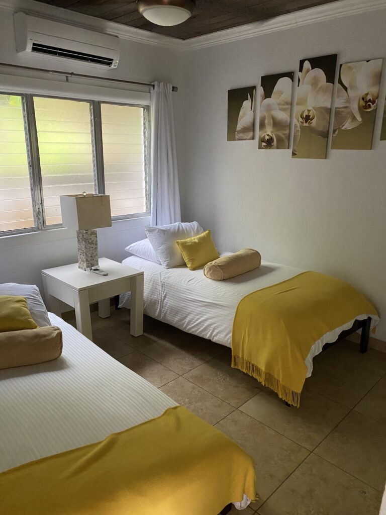 a room with two beds and a lamp