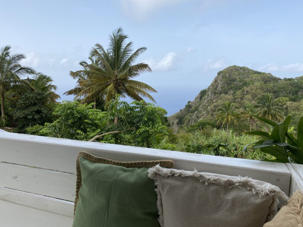 a balcony with a view of a tropical forest and mountains