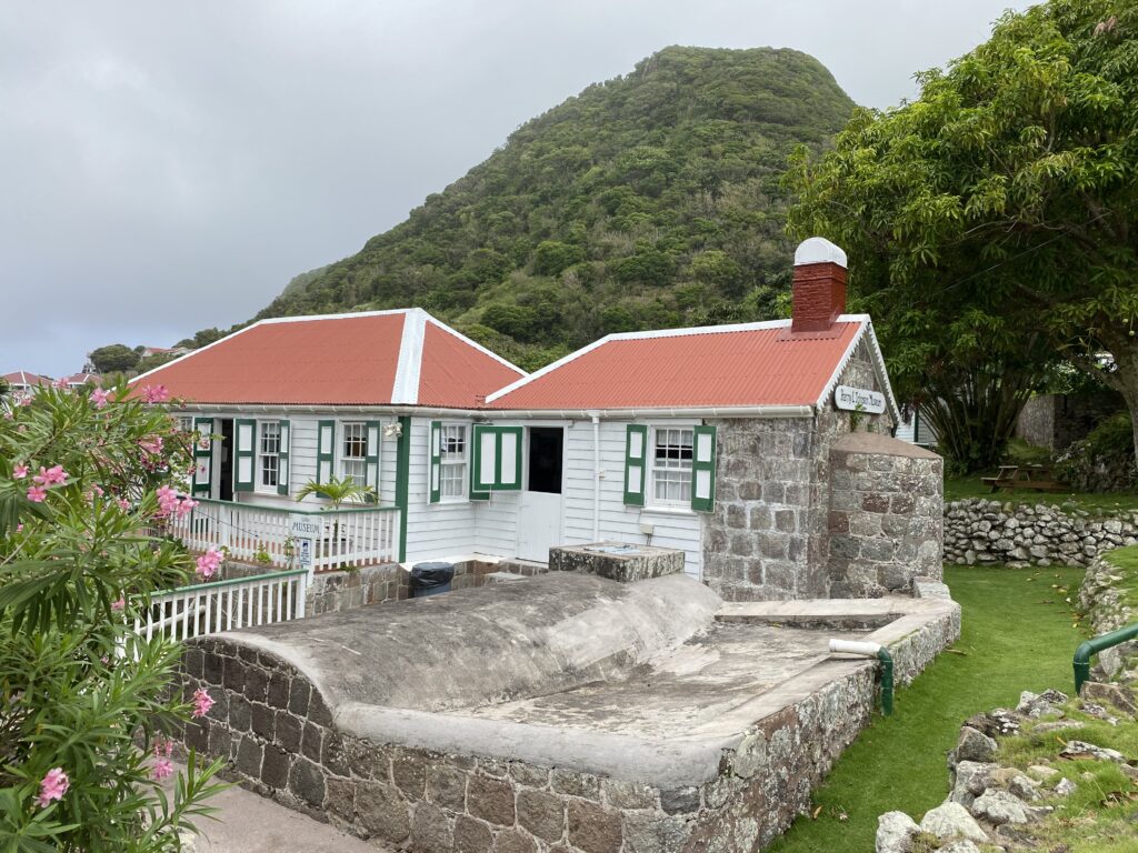 a house with a stone wall and a stone wall
