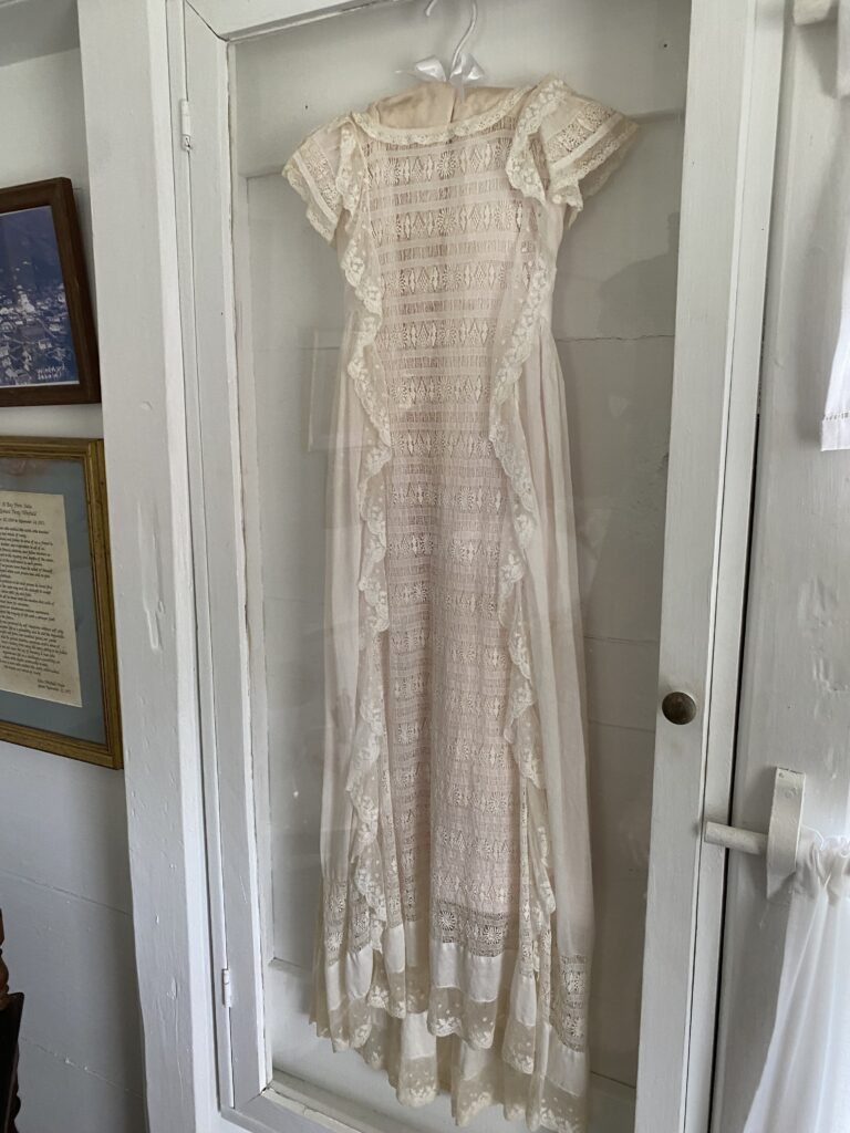a white dress in a glass case