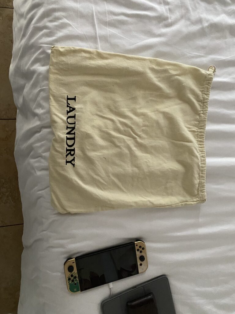 a phone and a bag on a bed