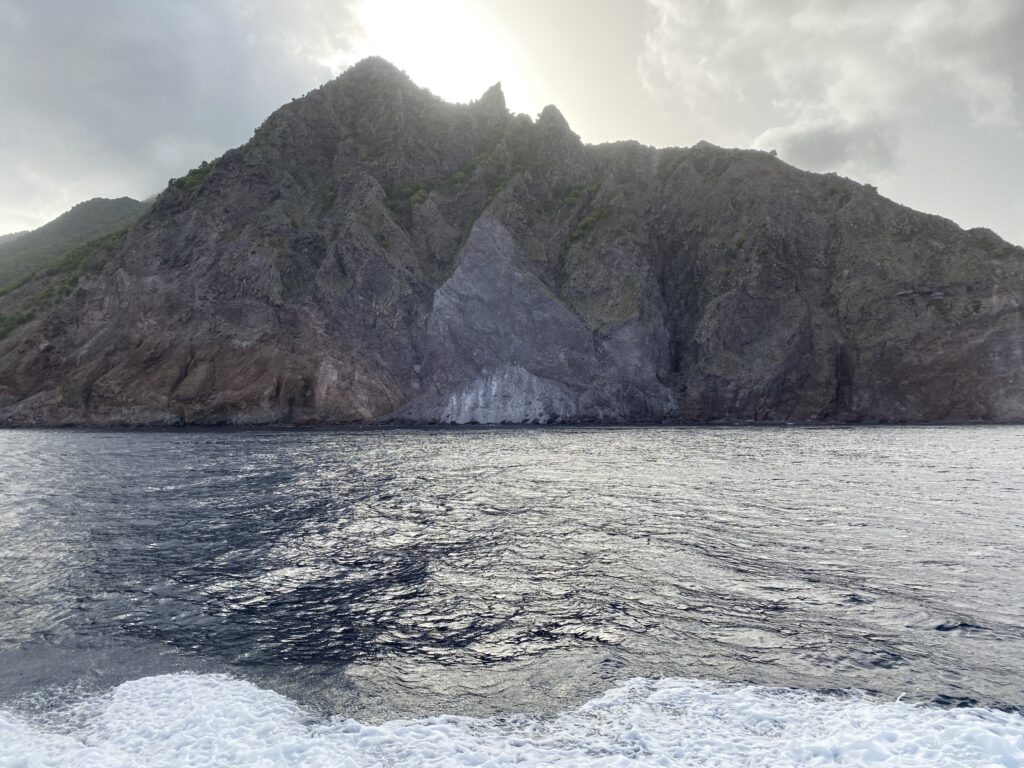 a large rocky mountain next to a body of water