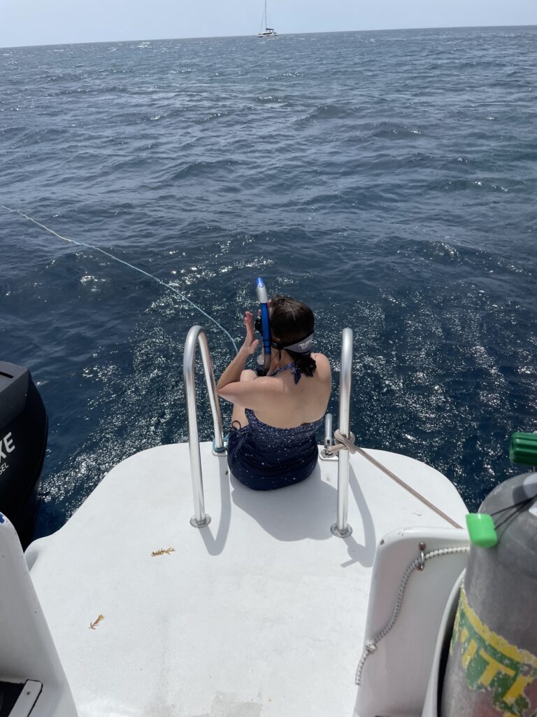 a woman sitting on a boat with a fishing line
