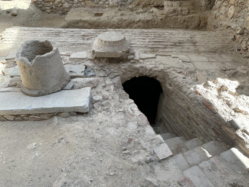 a stone stairs and a hole in the ground