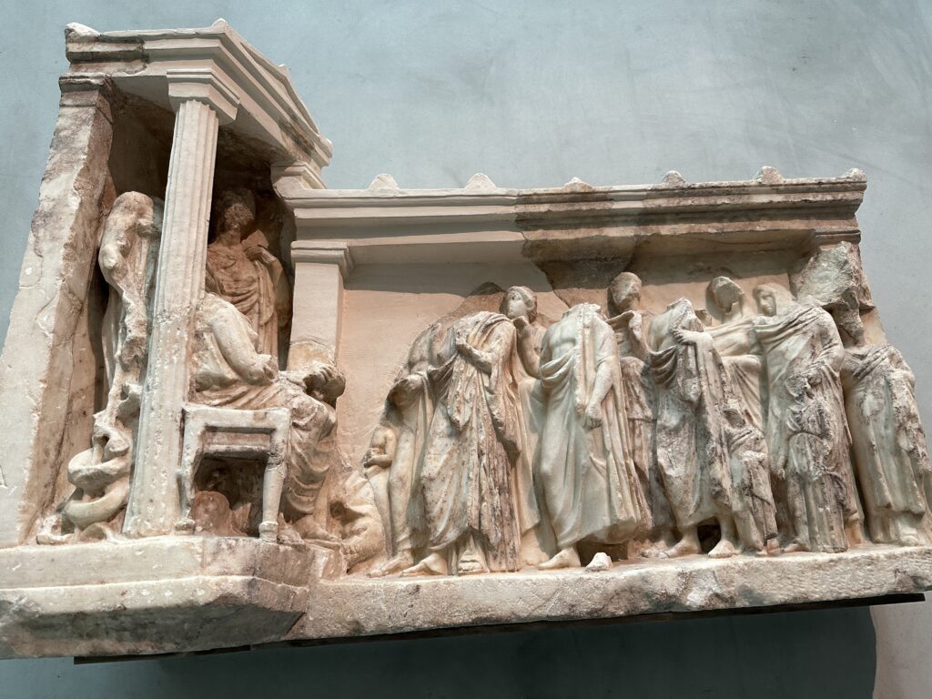 a sculpture of people on a wall