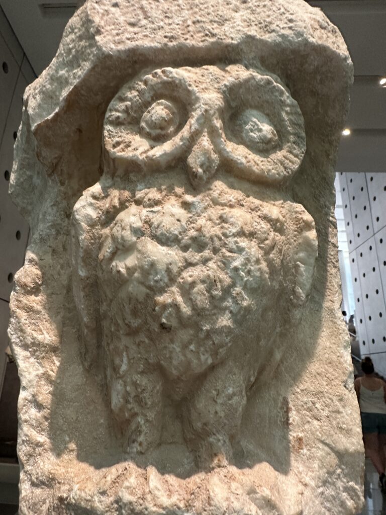 a stone sculpture of an owl