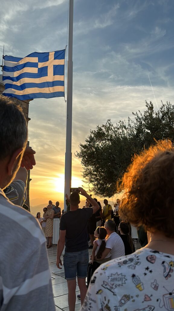 a group of people standing in front of a flag