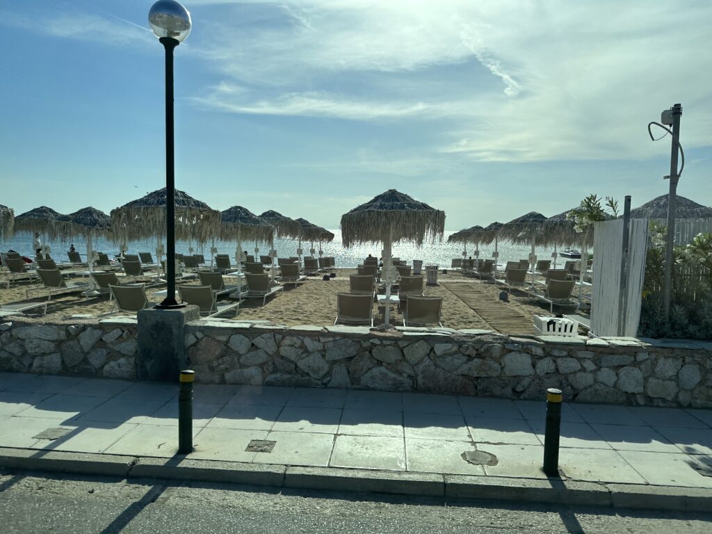 a beach with umbrellas and chairs