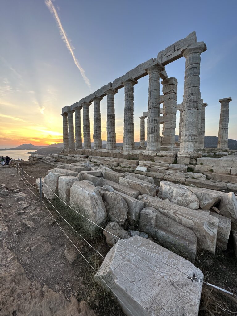 a stone structure with columns and rocks