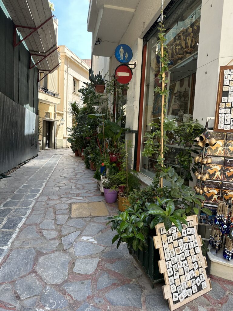 a street with plants and a sign on it