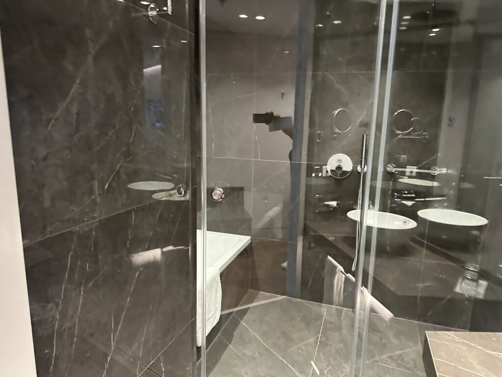 a glass shower door in a bathroom