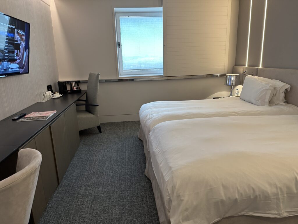 a room with two beds and a desk