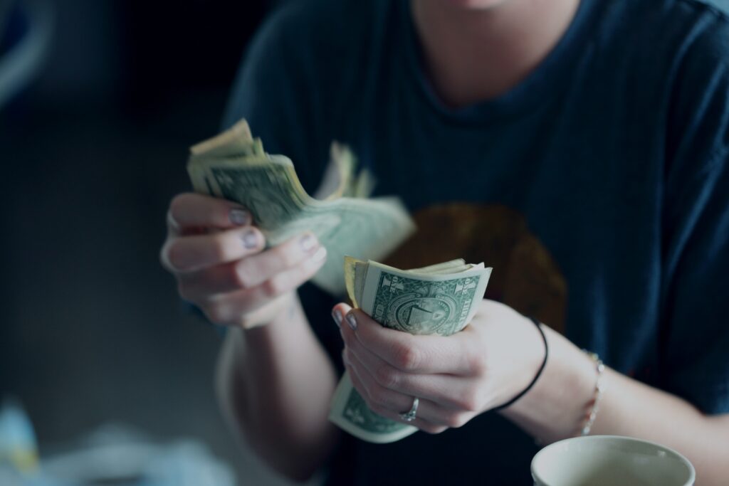 a person holding money in their hands