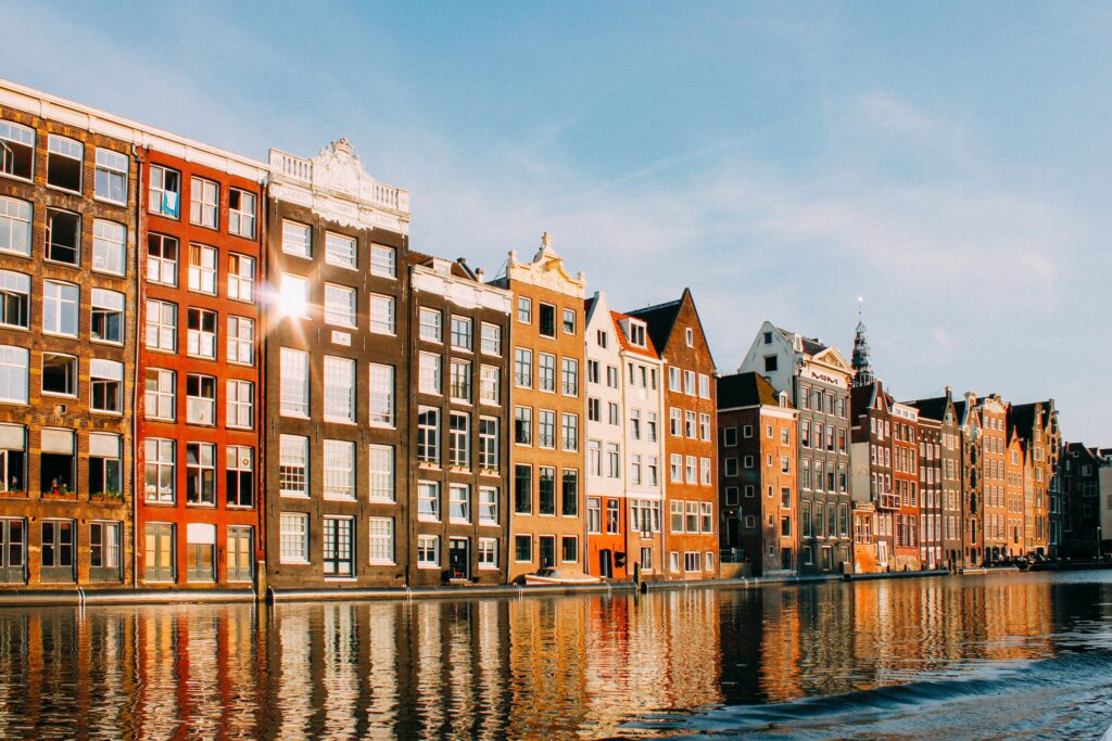 a row of buildings next to a body of water
