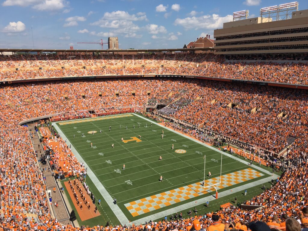 a football stadium with people in the stands with Neyland Stadium in the background
