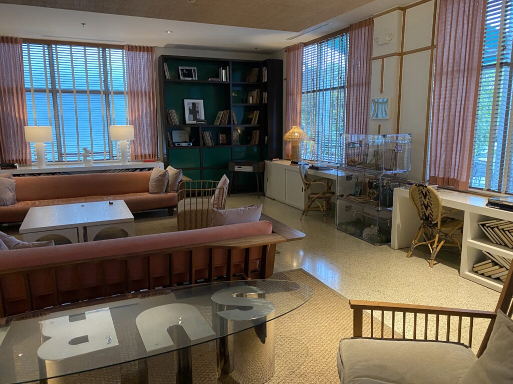 a room with a glass table and couches
