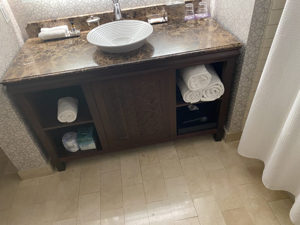 a bathroom sink with towels on the counter