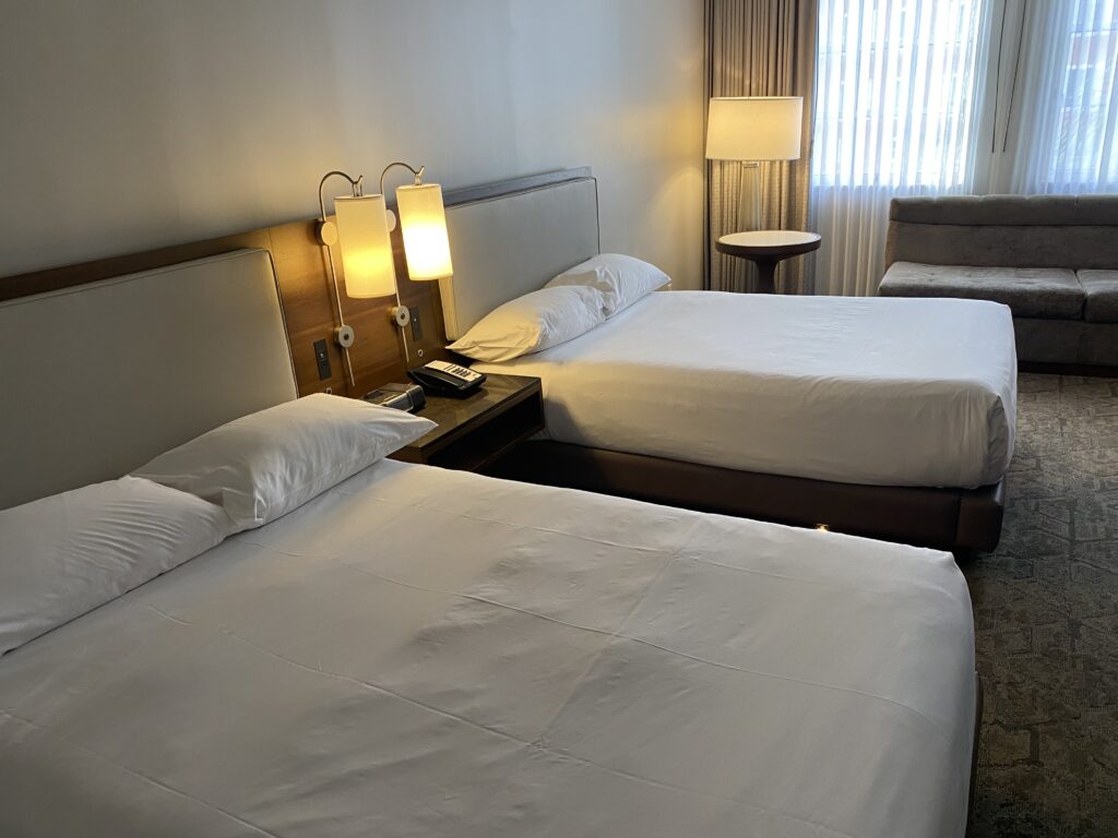 a room with two beds and a lamp