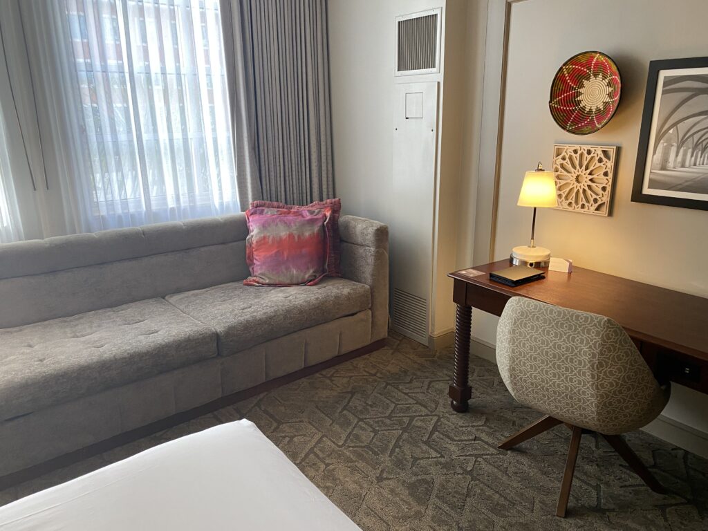 a room with a couch and a desk