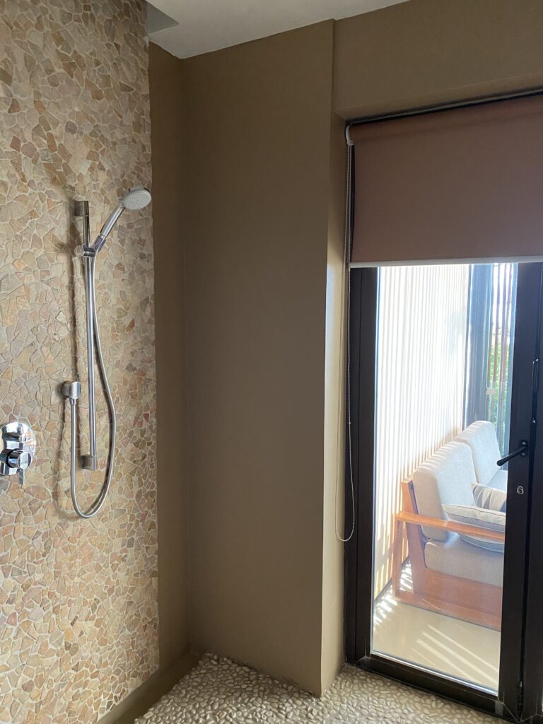 a shower with a sliding glass door