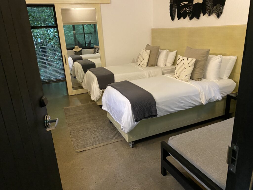 a room with beds and a door