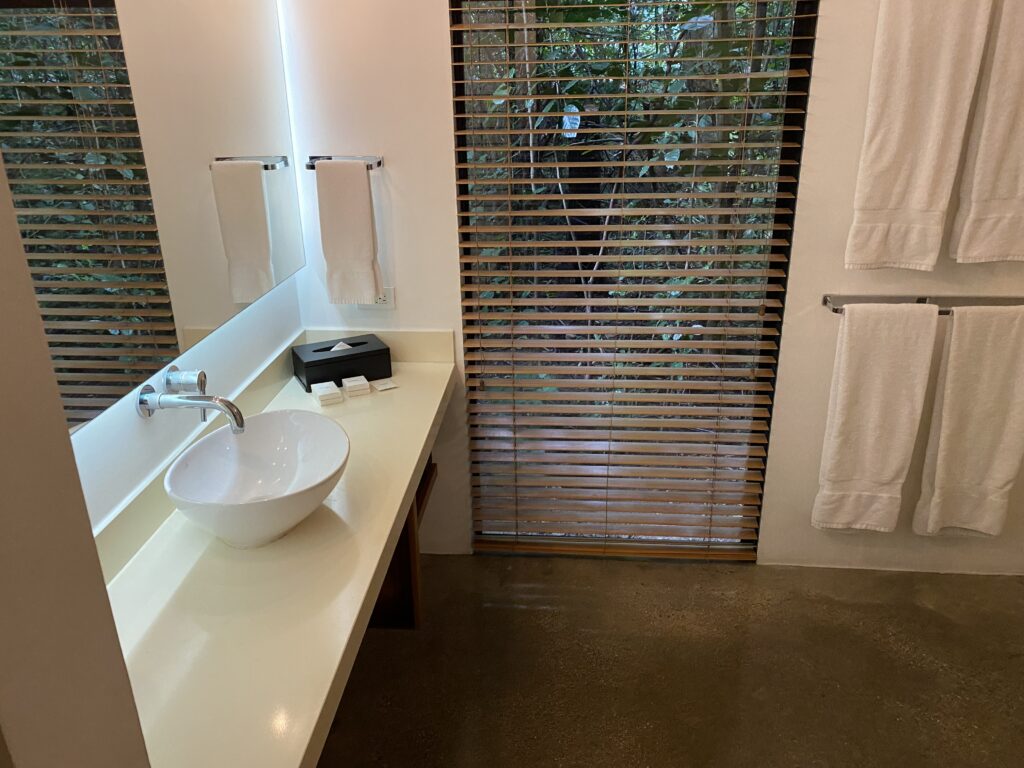 a bathroom with a sink and towel on the wall