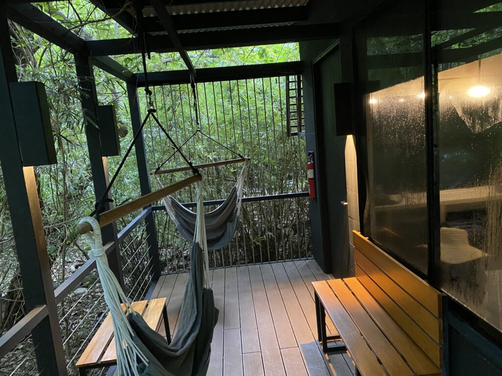 hammocks from a wooden bench on a porch