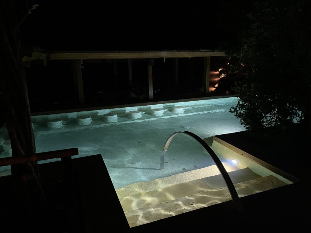 a pool with a railing at night