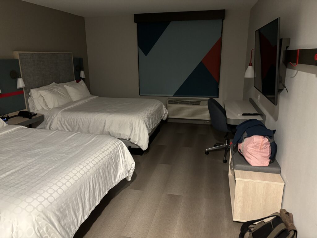 a room with two beds and a tv