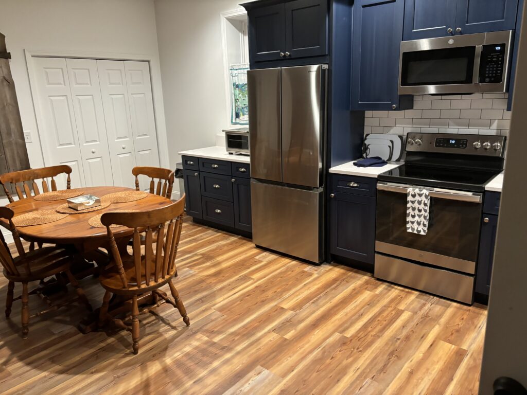 a kitchen with a table and refrigerator