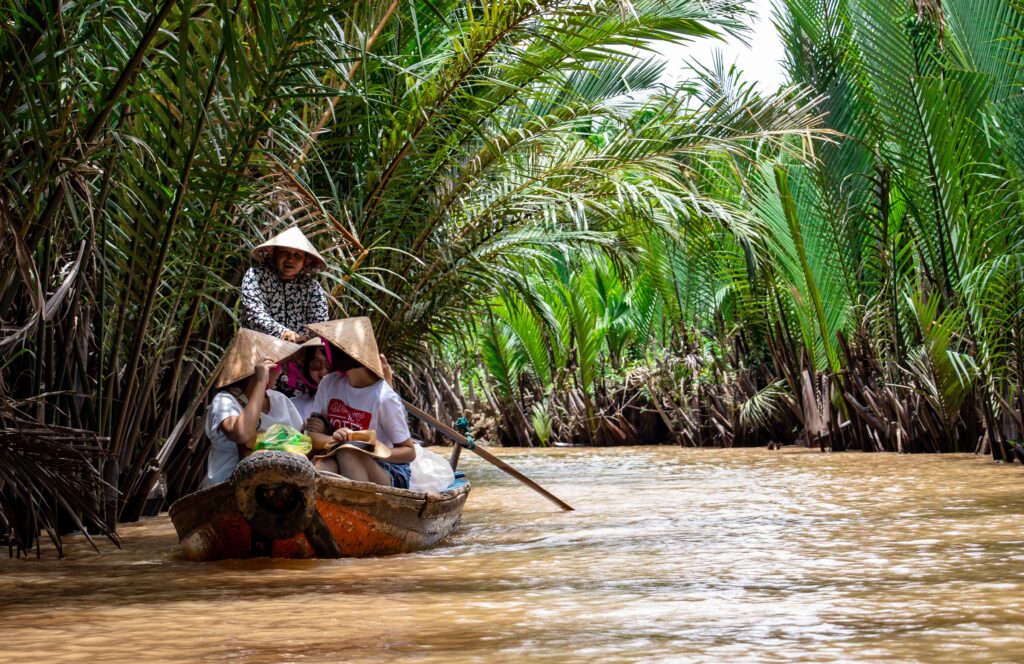 a group of people in a boat on a river