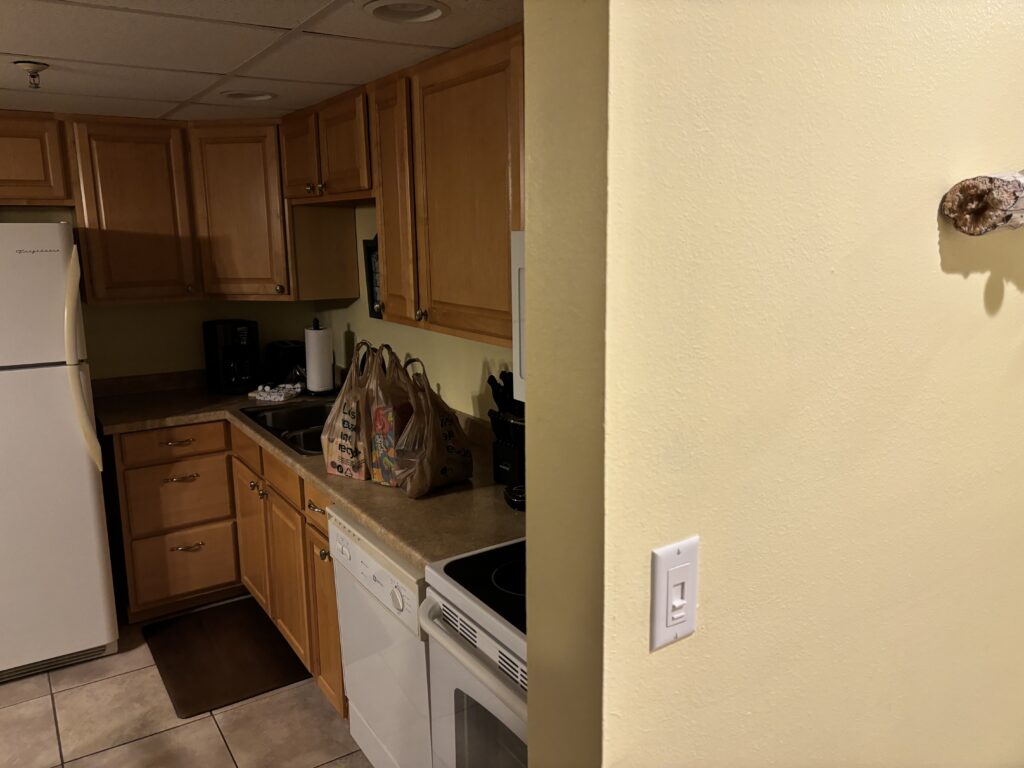 a kitchen with wooden cabinets and a white stove