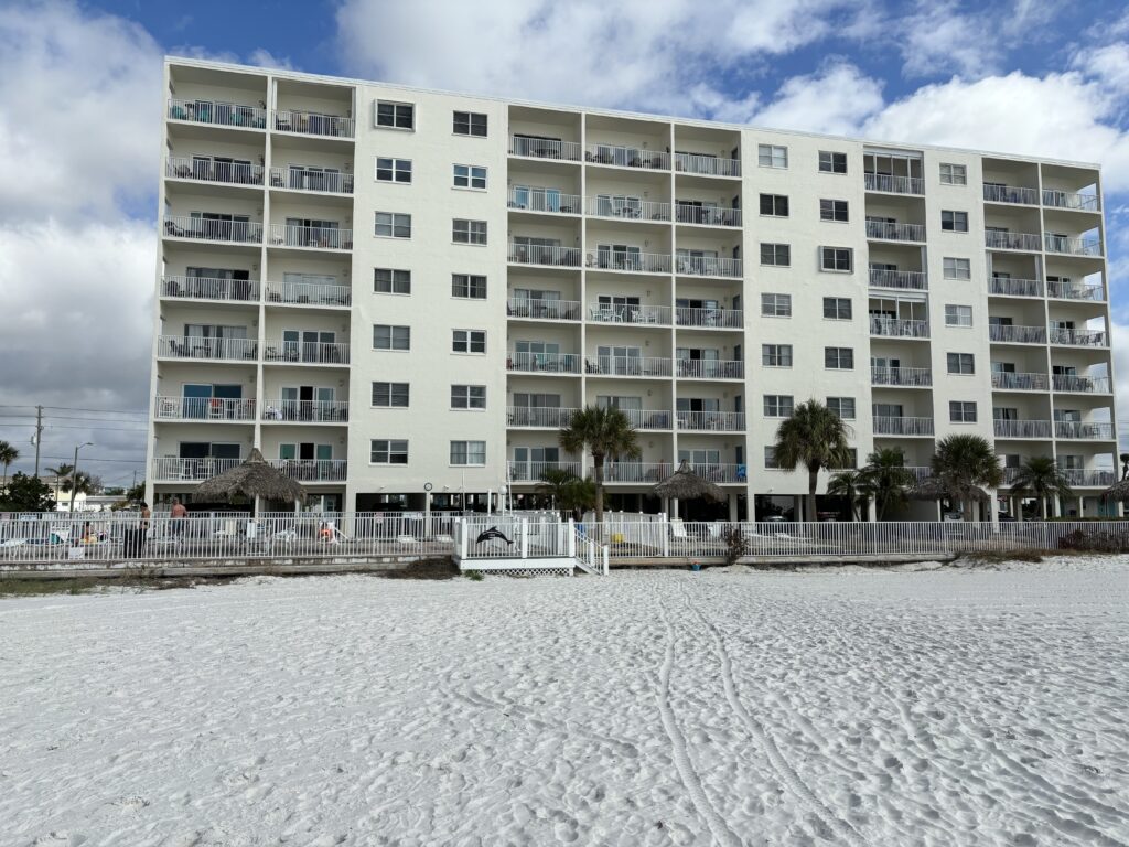 a building with many balconies and a beach