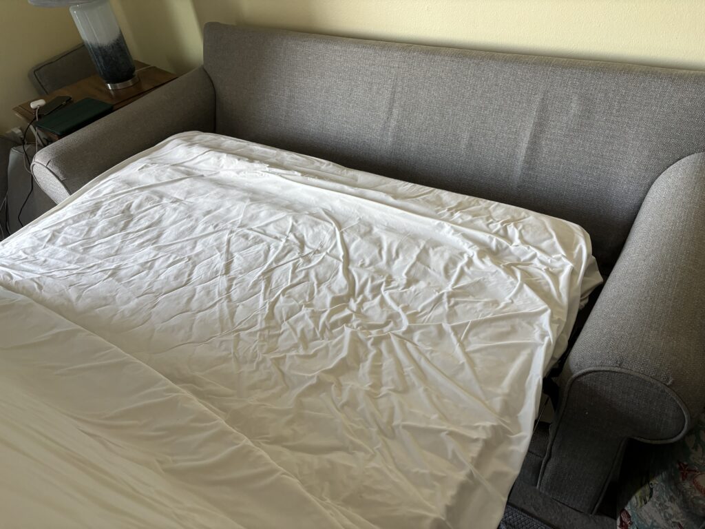 a couch with a white sheet