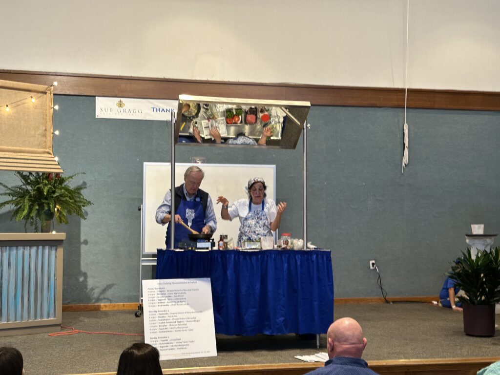 a man and woman cooking on a table