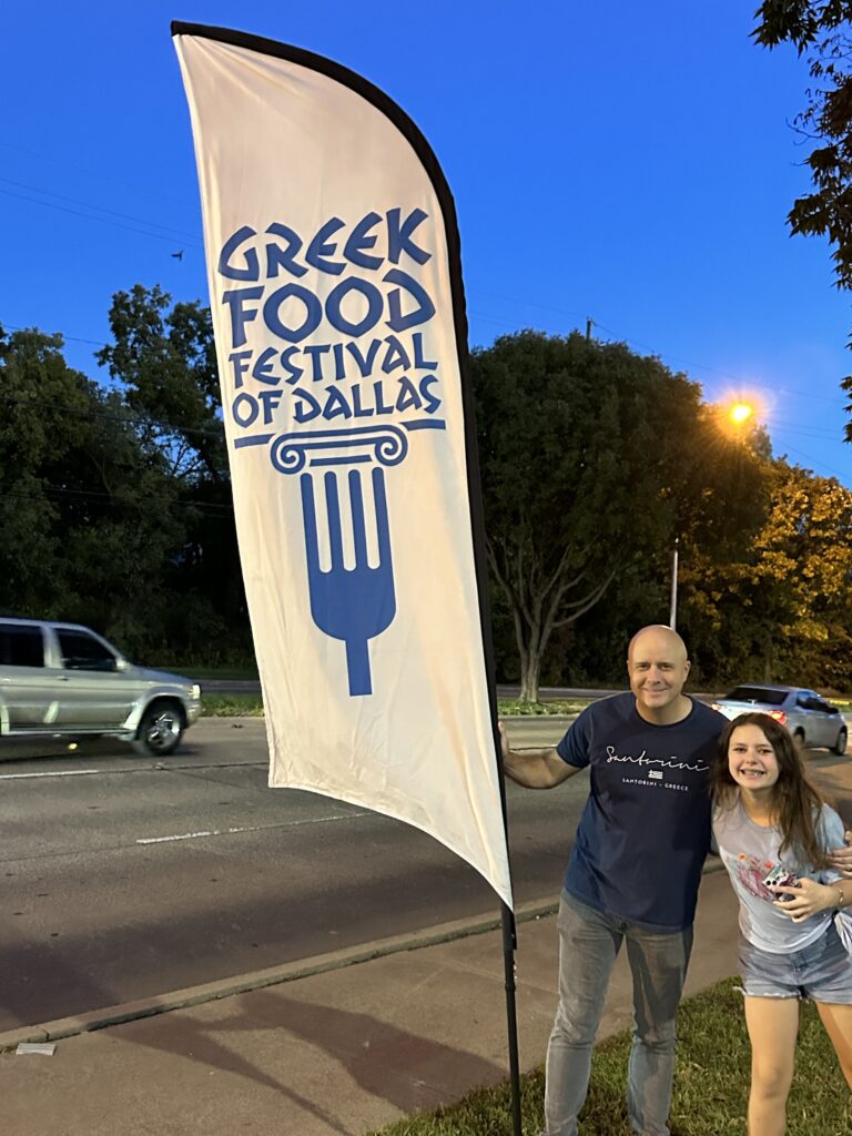 a man and woman standing next to a flag