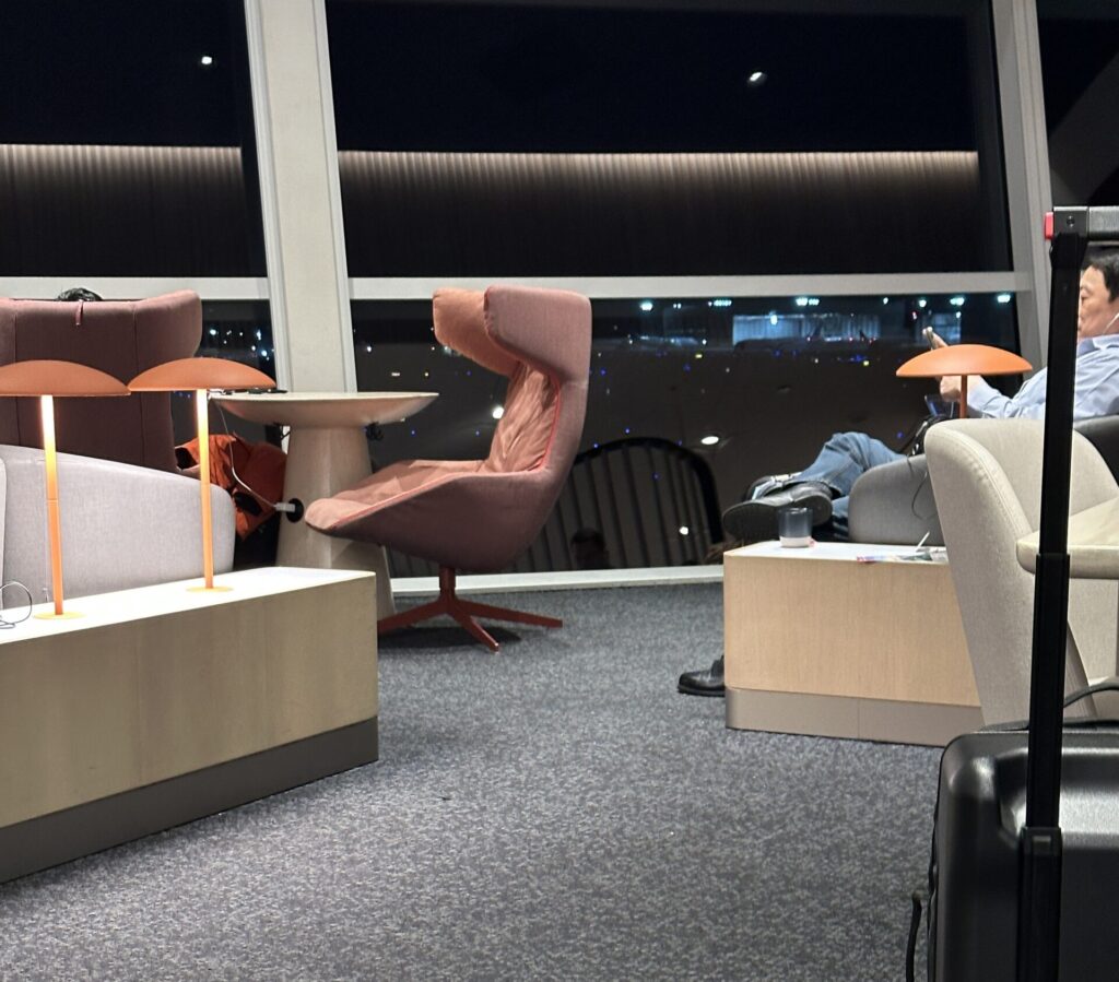 a room with chairs and tables and a window