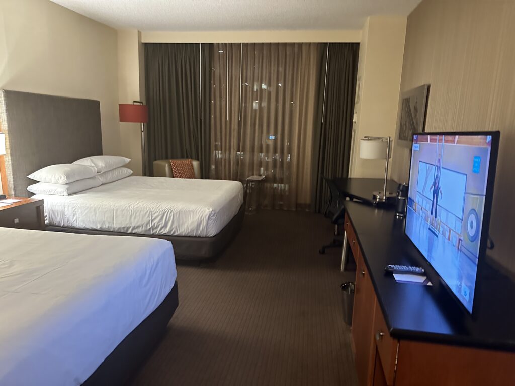 a room with two beds and a television
