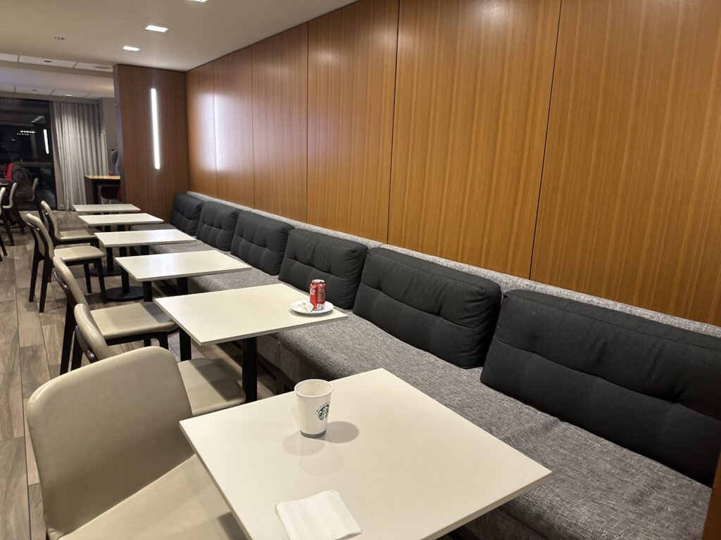 a long couch with tables and chairs