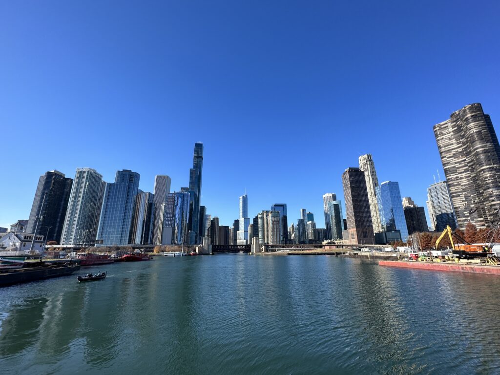 a city skyline with boats and a body of water