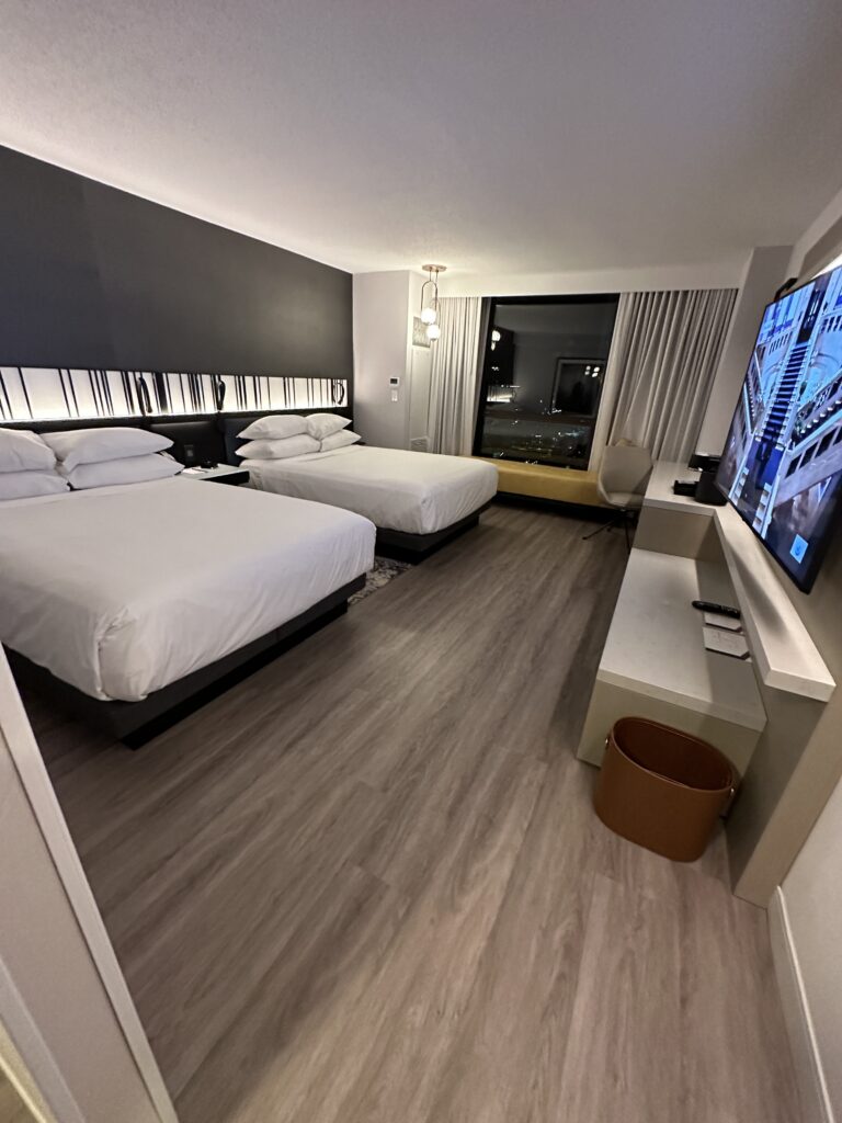 a room with two beds and a television
