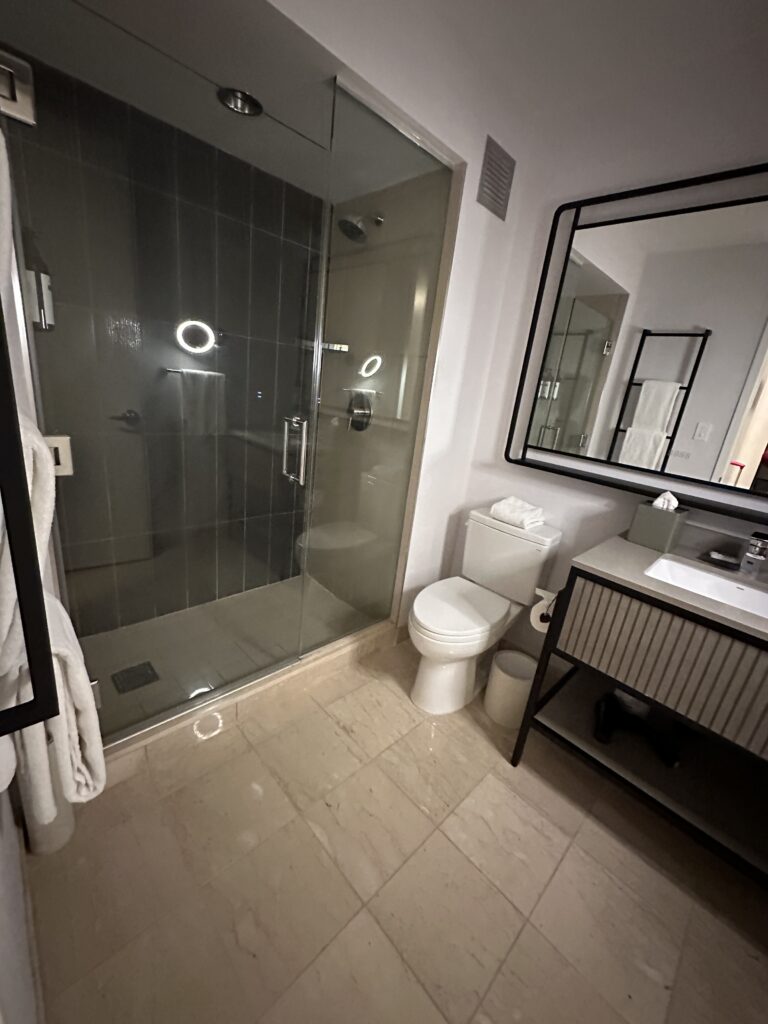 a bathroom with a glass shower and sink